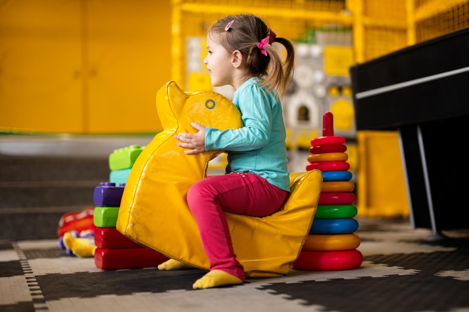 baby-girl-swings-on-yellow-paralon-duck-at-kinderg-2023-11-27-05-36-51-utc.jpg